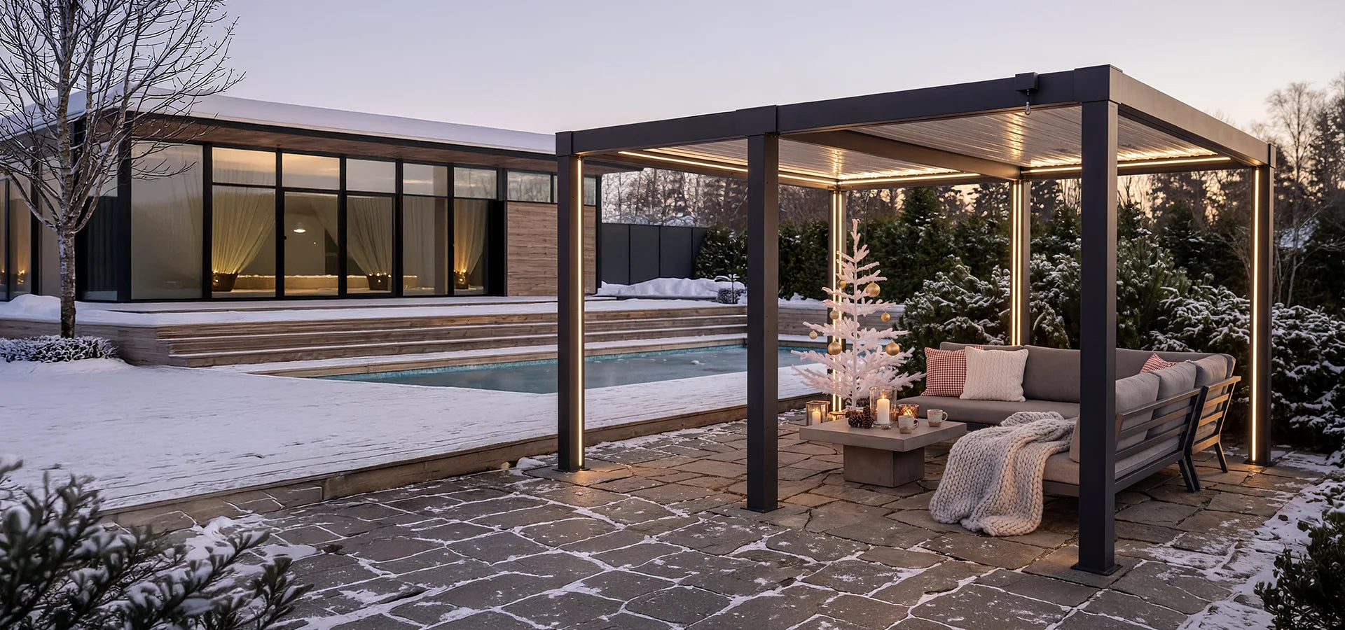 Outdoor patio area with a pergola, seating, and a pool in a snowy landscape.