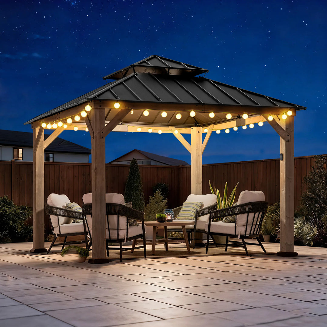Wooden gazebo with string lights on a patio at night