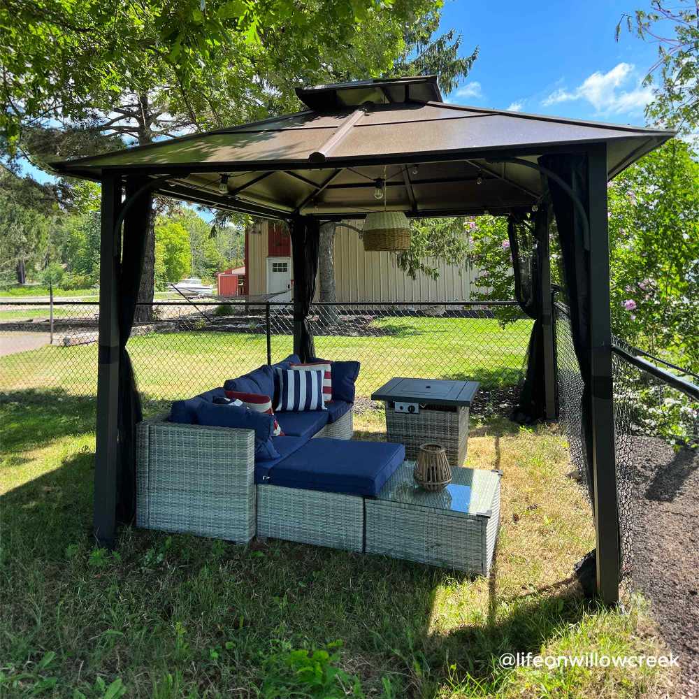 Outdoor gazebo with patio furniture under a clear blue sky