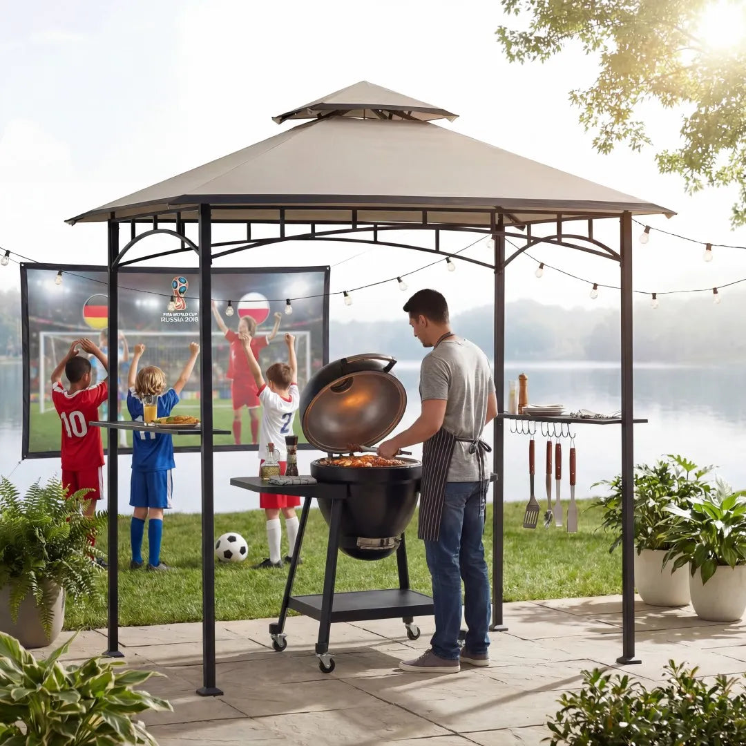 Man grilling in a gazebo with a TV screen displaying sports, surrounded by children and plants.