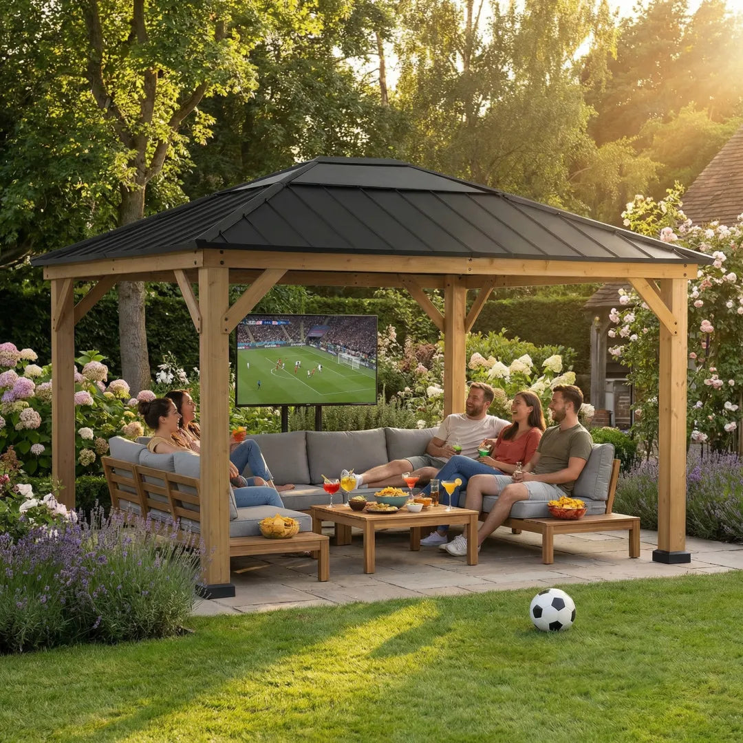People sitting under a wooden gazebo watching TV in a garden setting.