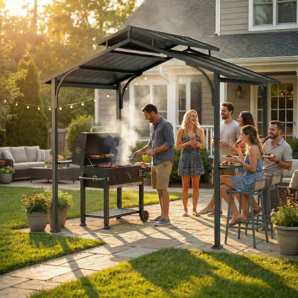People gathered around a grill under a hardtop grill gazebo in a backyard setting.