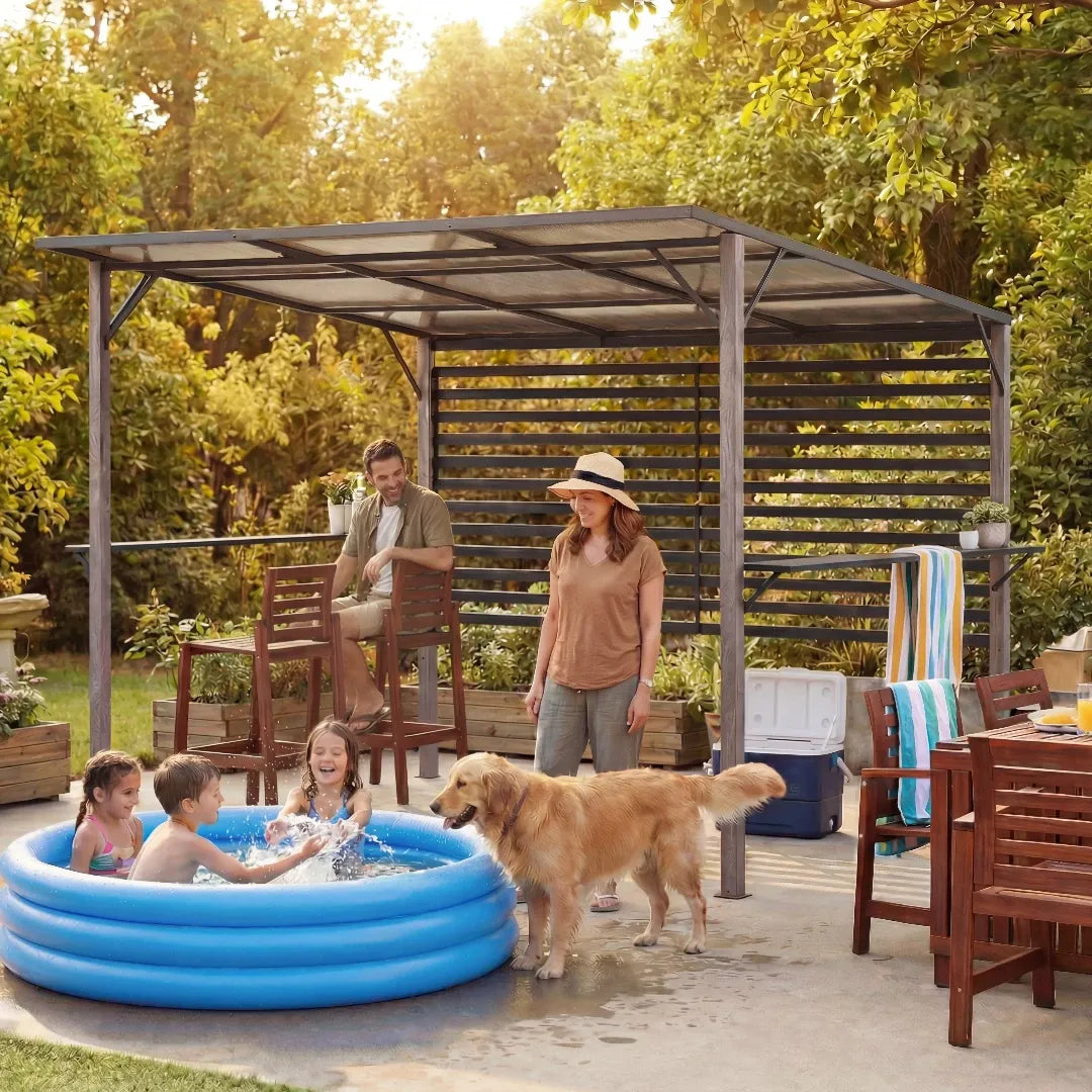 Family with children and a dog playing in an inflatable pool under a patio pergola in a backyard setting.